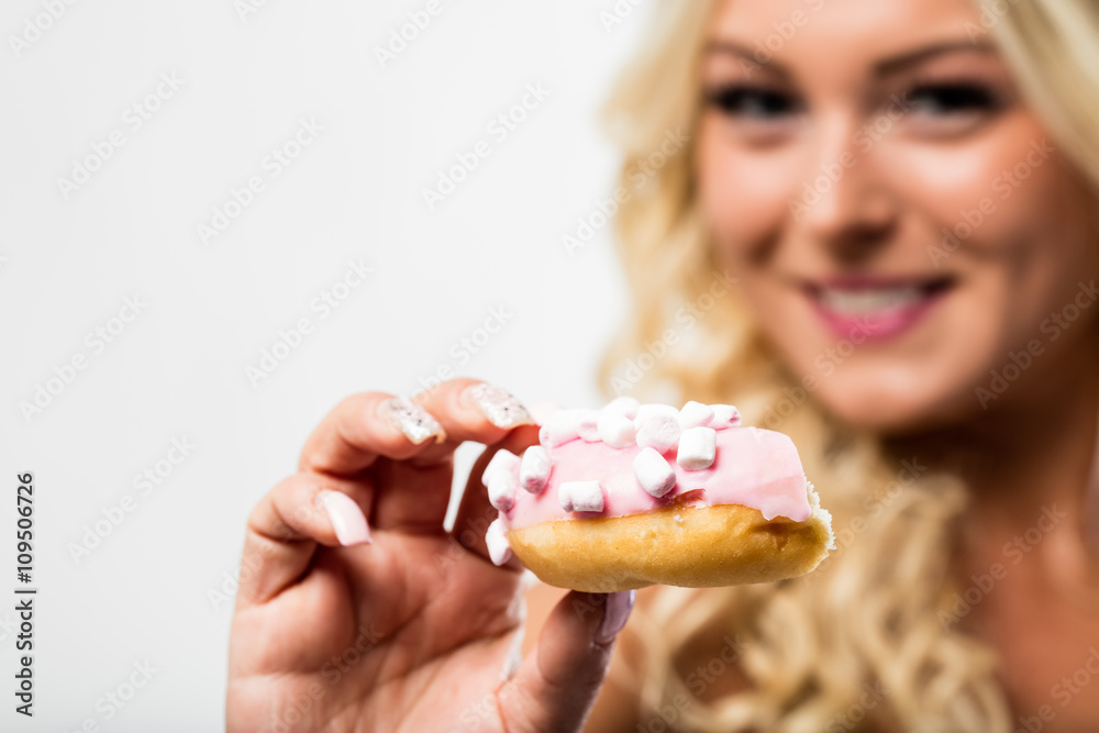 donut in focus with blurred woman in background donut in focus with blurred woman in background