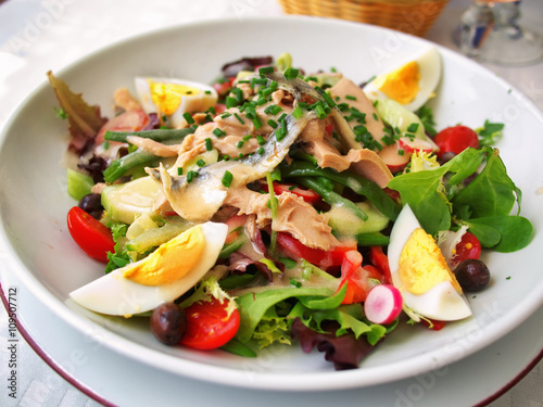 Nicoise Salad served in a restaurant in Cannes, France. Horizontal, tilted view