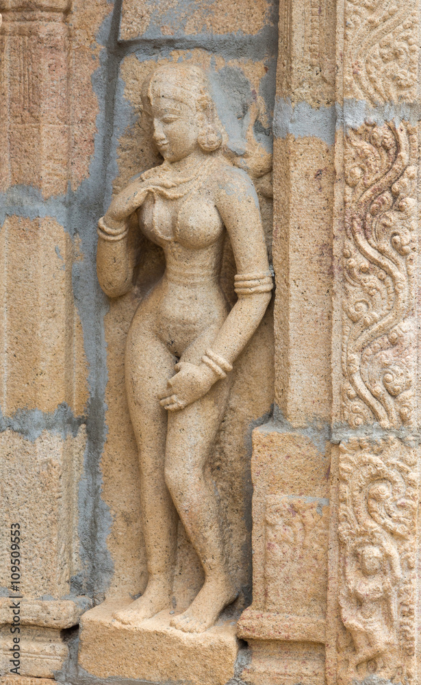 Trichy, India - October 15, 2013: Sandstone statue of naked woman at Ranganathar Temple. Outside wall of old part built during Madurai Nayak era.