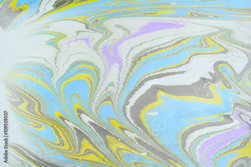 Ebru art. Traditional Turkish Ebru technique. Marbling painting on water transferred on highly textured paper or cloth. Color paint ebru with waves and tile pattern.