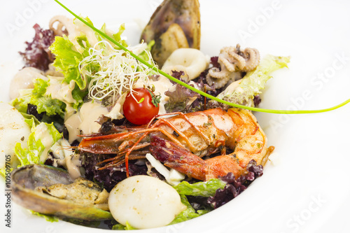 salad with vegetables and seafood on the table in a restaurant