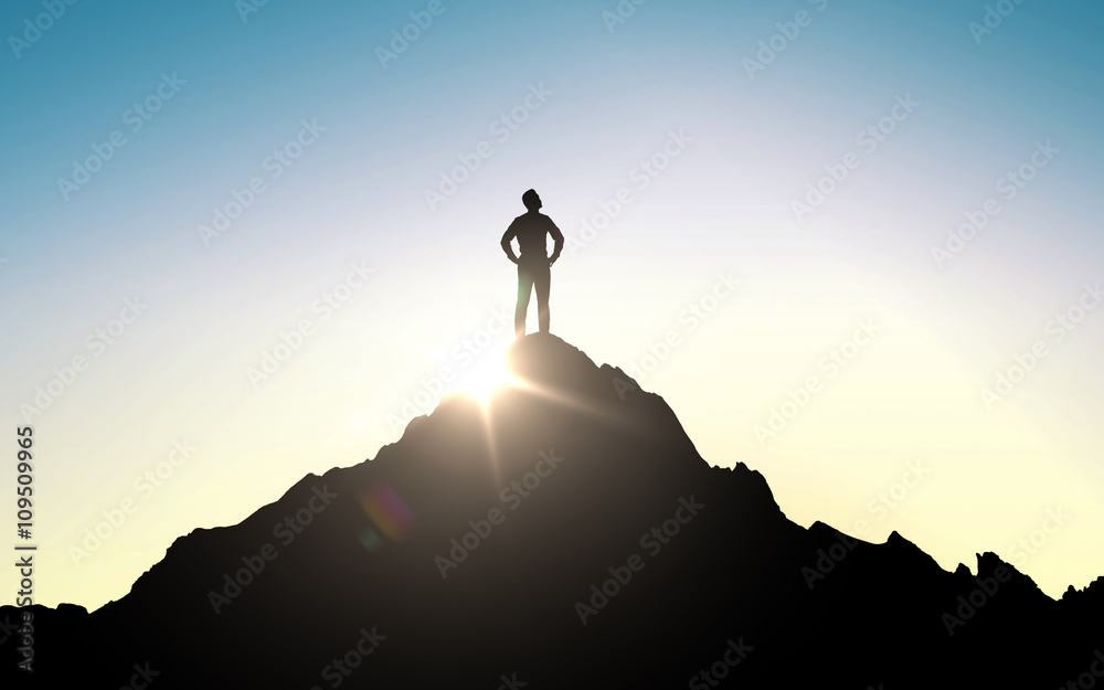 silhouette of businessman on mountain top
