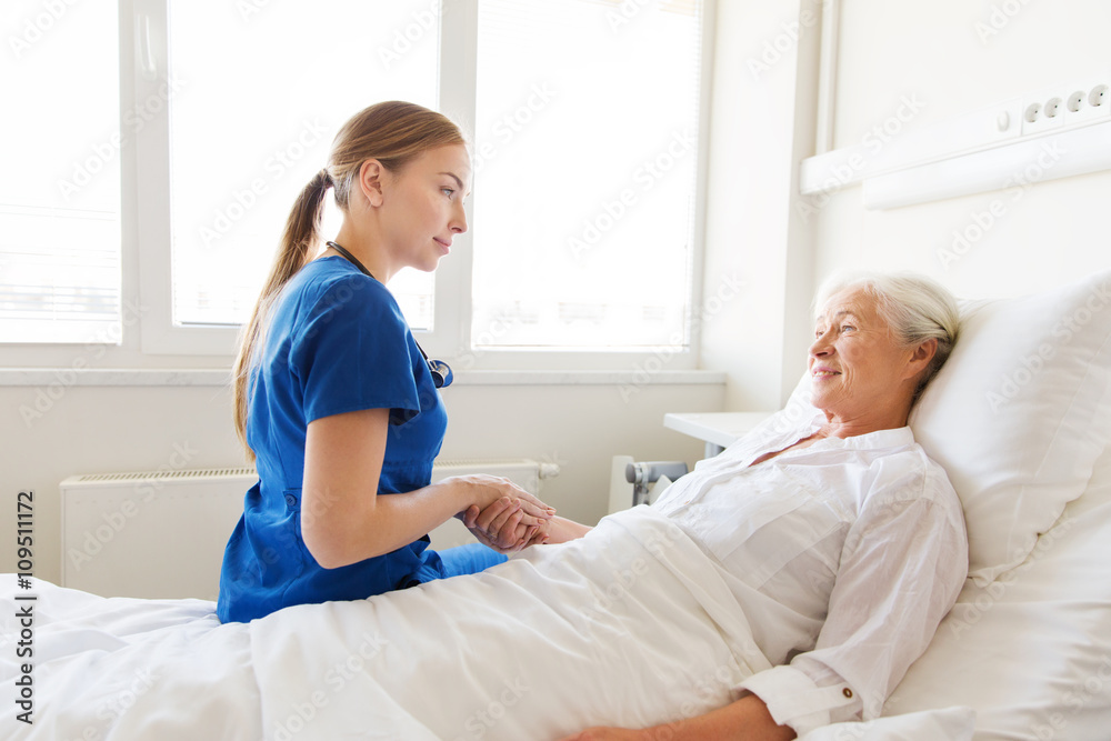 Fototapeta premium doctor or nurse visiting senior woman at hospital