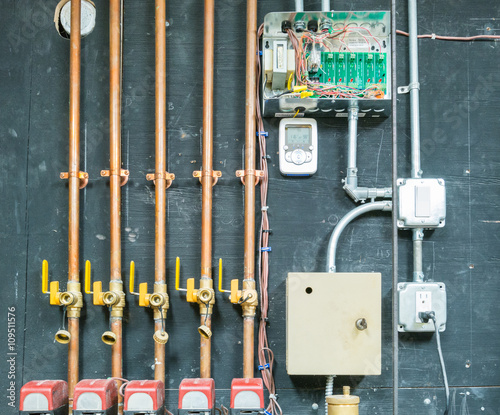 Row of copper pipes with control unit