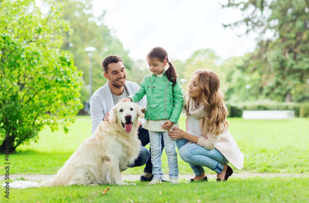 Obraz premium happy family with labrador retriever dog in park