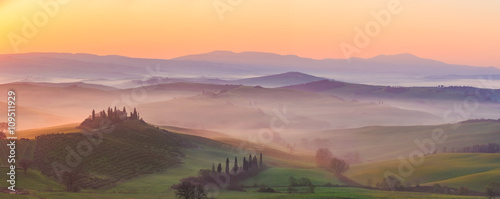 Fotografie, Tablou Misty sunrise in the Val d’Orcia, or Valdorcia, a region of Tuscany, central Italy, which extends from the hills south of Siena to Monte Amiata