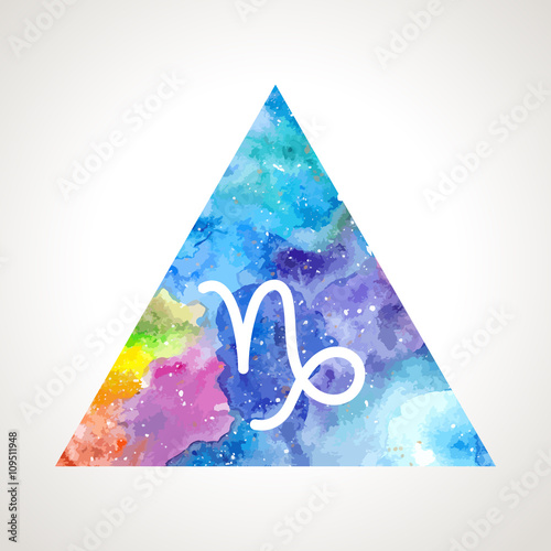 Capricorn zodiac sign on watercolor triangle background. Astrology symbol