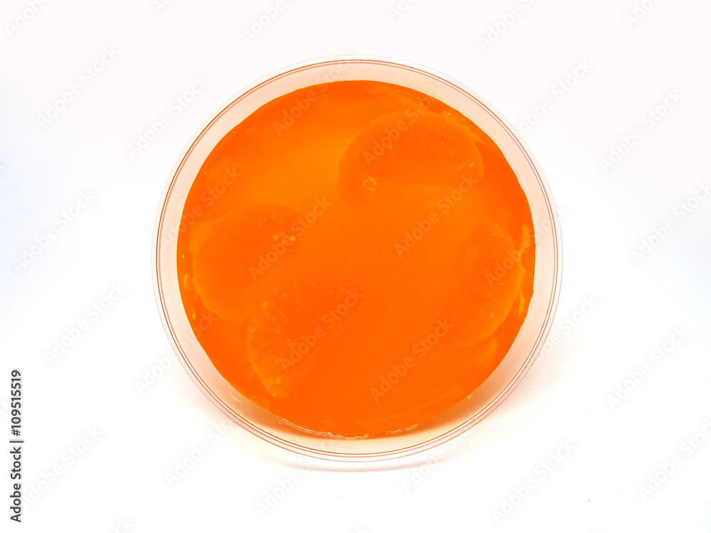 Orange jelly with fruit piece in a plastic cup Orange jelly with fruit piece in a plastic cup