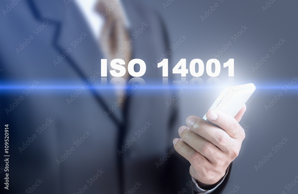 Businessman pressing hand ISO 14001 message on virtual screen. Can bring to the medium of your ad. Businessman pressing hand ISO 14001 message on virtual screen. Can bring to the medium of your ad.