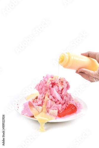 Shaved ice with condensed milk on white background