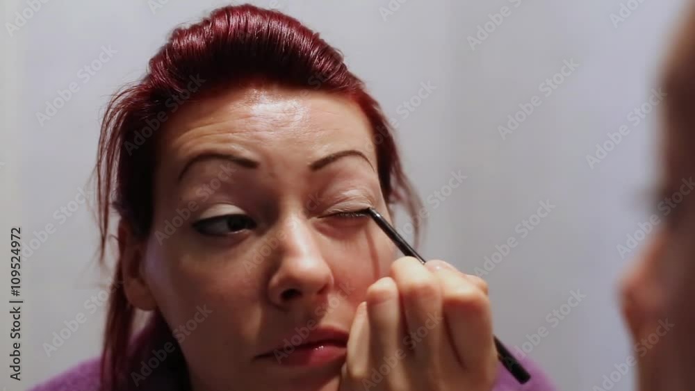 Female Doing Eyelashes Make up Female Doing Eyelashes Make up