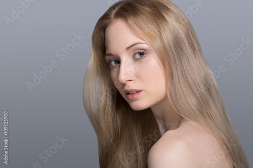 Beautiful blond woman with cotton flowers-skin care concept