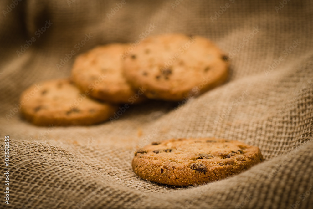 Christmas cookies on a wooden table covered in jute. Horizontal concept image for holiday background. Christmas cookies on a wooden table covered in jute. Horizontal concept image for holiday background.