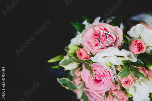 Wedding diamond rings on bride's bouquet