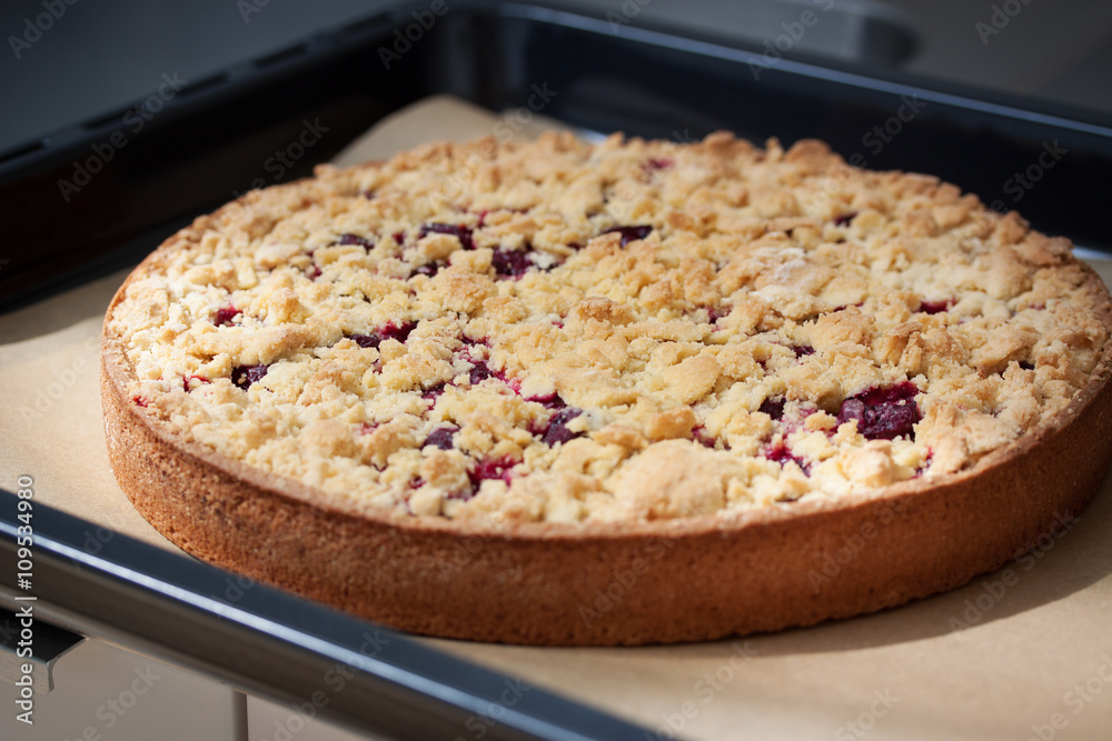Homemade fresh sweet cherry crumble pie with whole wheat flour on kitchen background ready to bake, closeup