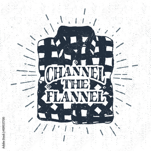 Hand drawn vintage label with textured plaid shirt vector illustration and "Channel the flannel" lettering.