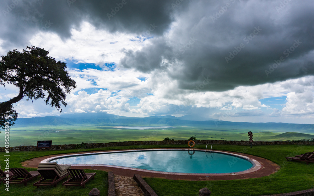 evening view from a safari lodge on the Ngorongora Crater rim with dark stormy clouds 
