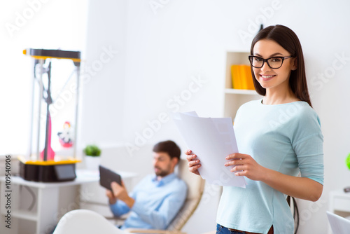 Positive woman holding papers