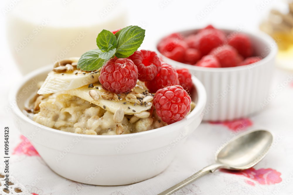 Porridge with addition of fresh raspberries, bananas, roasted sunflower and chia seeds Porridge with addition of fresh raspberries, bananas, roasted sunflower and chia seeds