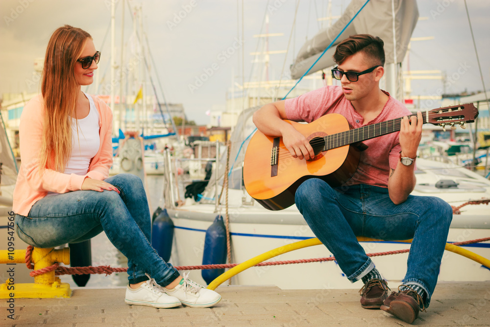 Happy couple with guitar outdoor