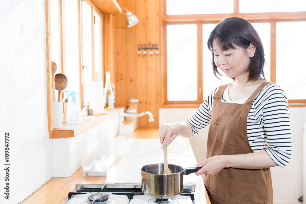 attractive asian woman cooking in the ktichen attractive asian woman cooking in the ktichen