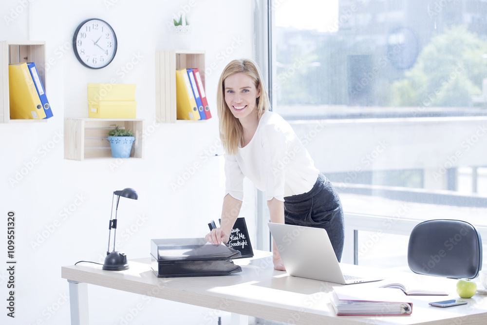 Beautiful young business woman in office