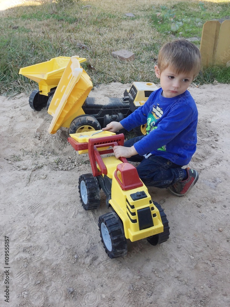 playing outside with his toy trucks playing outside with his toy trucks