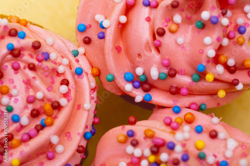 cropped image of strawberry cupcake with icing.