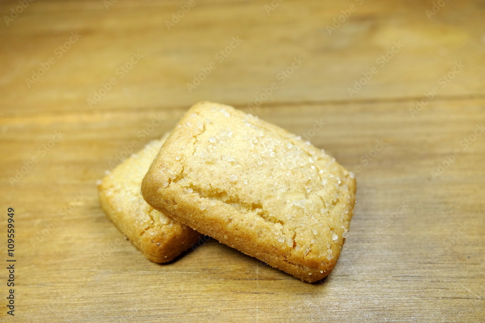 Butter cookies on a wood background.