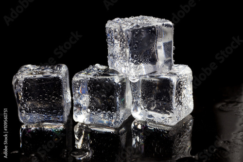 ice cubes on reflection black background.