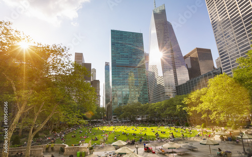 Crowds in Central Park and city skyline, New York, USA