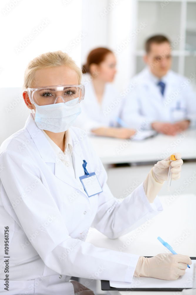 Scientific research team with clear solution in laboratory Scientific research team with clear solution in laboratory