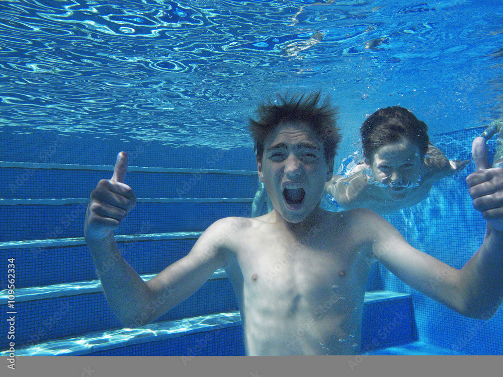 Underwater view of boy giving thumbs up in swimming pool Stock Photo ...
