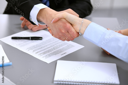 Business people shaking hands , finishing up a meeting to sign a new contract