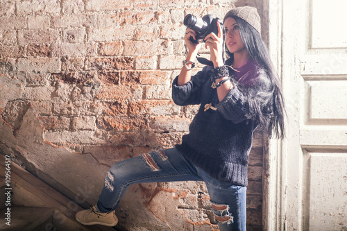 Young female photographer photographing stairs in old industrial building photo