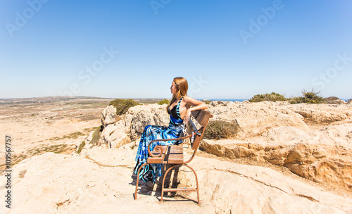 young beautiful caucasian female on a cliff above the sea