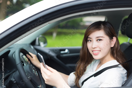 young beautiful asian girl in car