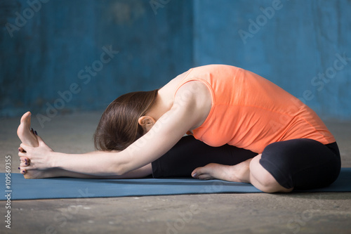 Sporty beautiful young woman doing Hamstring Stretch exercise
