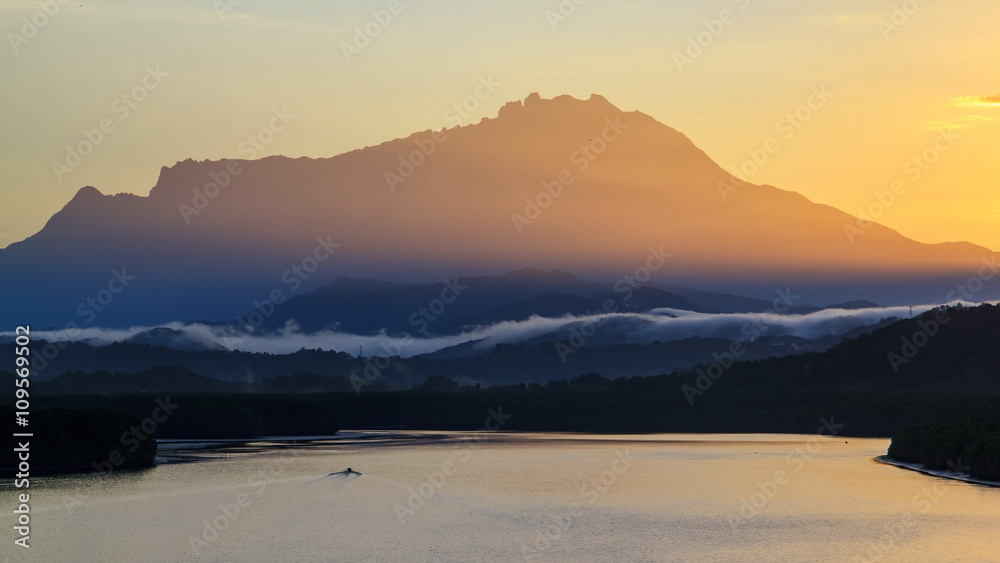 Majestic sunrise over the kinabalu mountain , Beautiful sunrise at Mengkabong river, The magnificent Mount Kinabalu early morning.