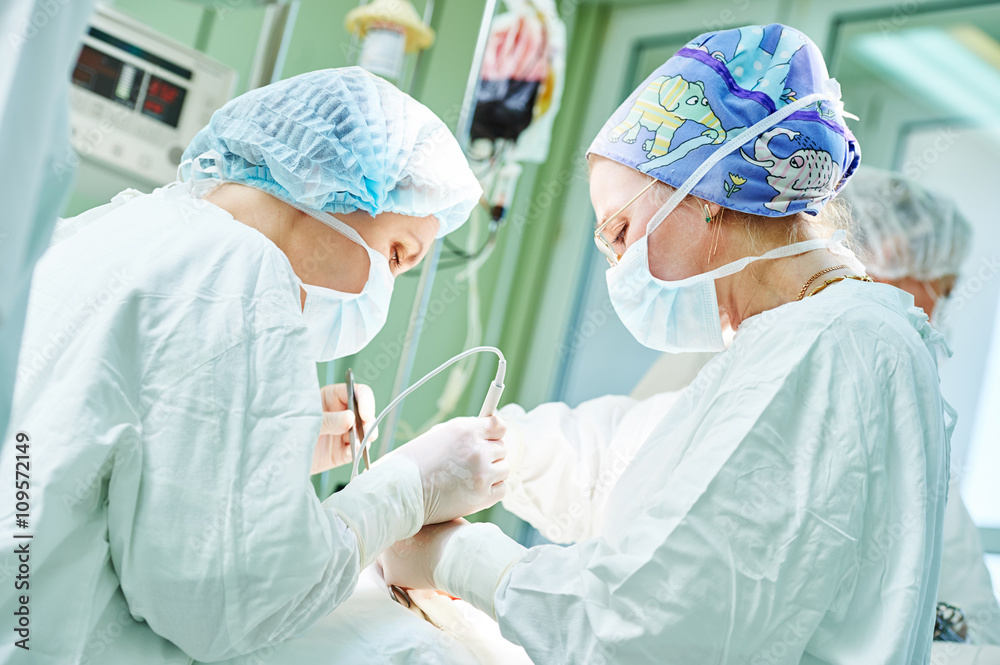 surgeons at work. female doctors operating in child surgery hospital surgeons at work. female doctors operating in child surgery hospital