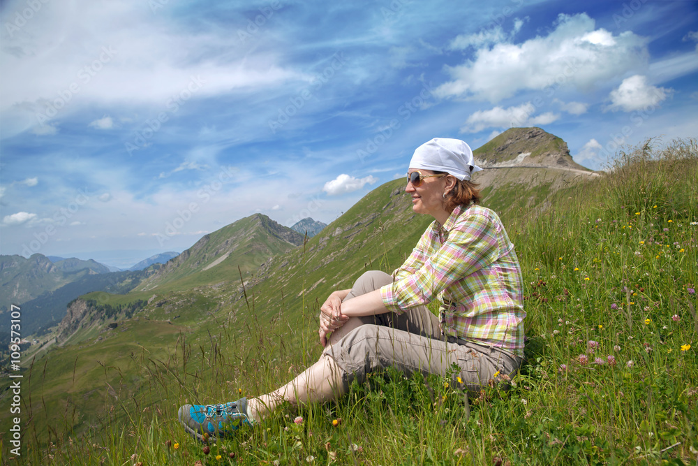 Caucasian woman sitting on a mountain