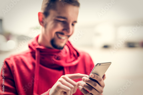 Happy man using smartphone.