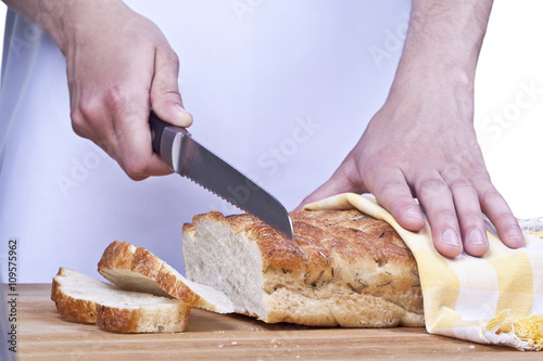 human hand cutting bread