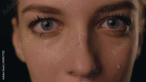 Closeup view of face of SAD Young Woman Crying and having problems with private life. Girl in depression because of home violence. She is disappointed. Tears on face. ideal for social ads. 4K video