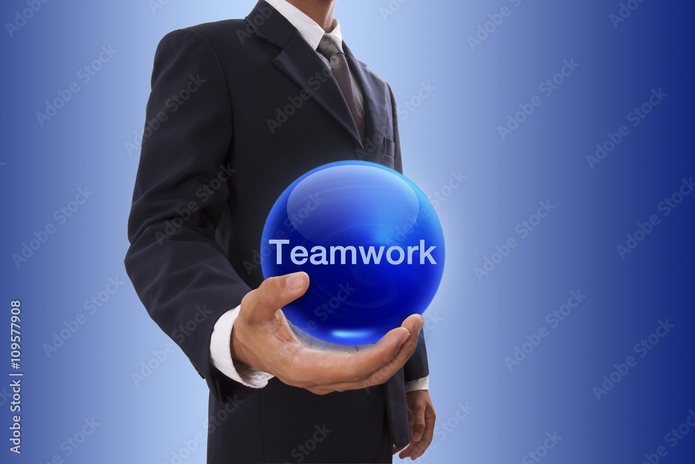 Businessman hand holding blue crystal ball with teamwork word. Businessman hand holding blue crystal ball with teamwork word.