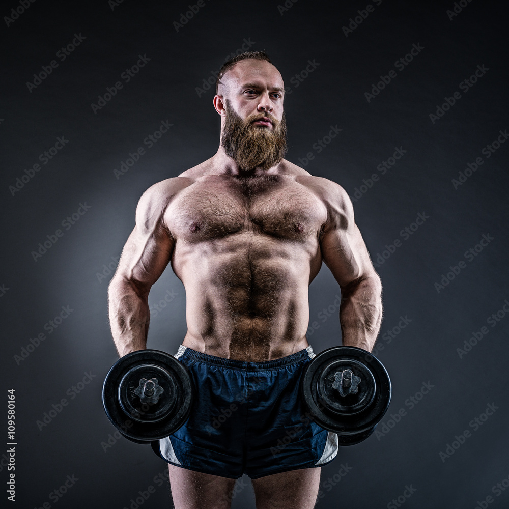 Strong bodybuilder with six pack, perfect abs, shoulders, biceps Strong bodybuilder with six pack, perfect abs, shoulders, biceps