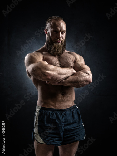 Bodybuilder topless over grunge background.