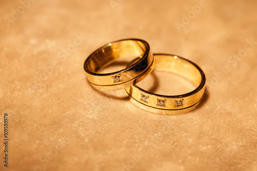 Wedding rings on a yellow background
