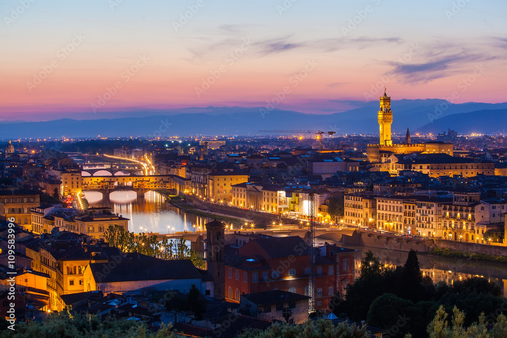 View of the river embankment of Arno and cathedrals of Florence from Michelangelo's hill on a sunset