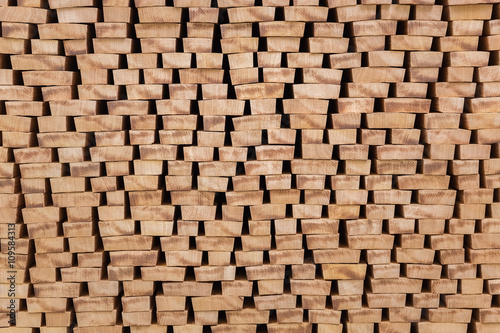 The ends of processed lumber stacked on the open air